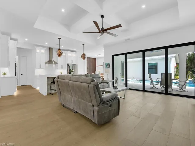 a living room with furniture and large windows