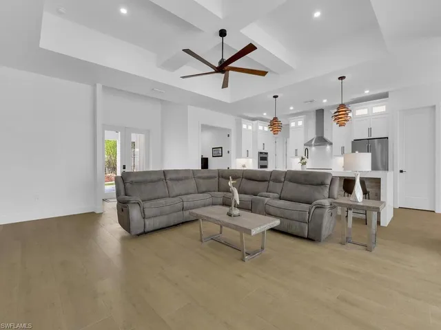 a living room with furniture and a ceiling fan