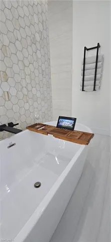 a living room with furniture and a ceiling fan