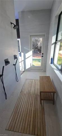 a kitchen with kitchen island stainless steel appliances a dining table and chairs