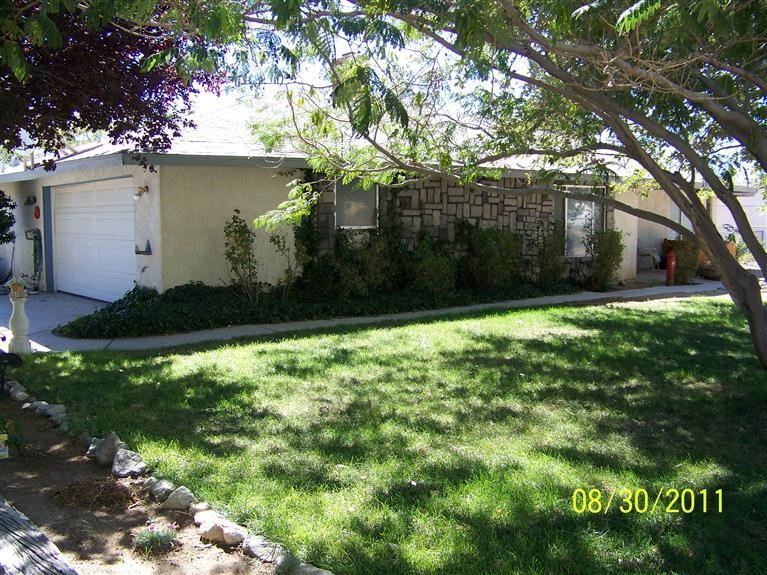 16393 Sago Road Apple Valley, CA 92307 - Photo 1 of 1 a backyard of a house with lots of green space