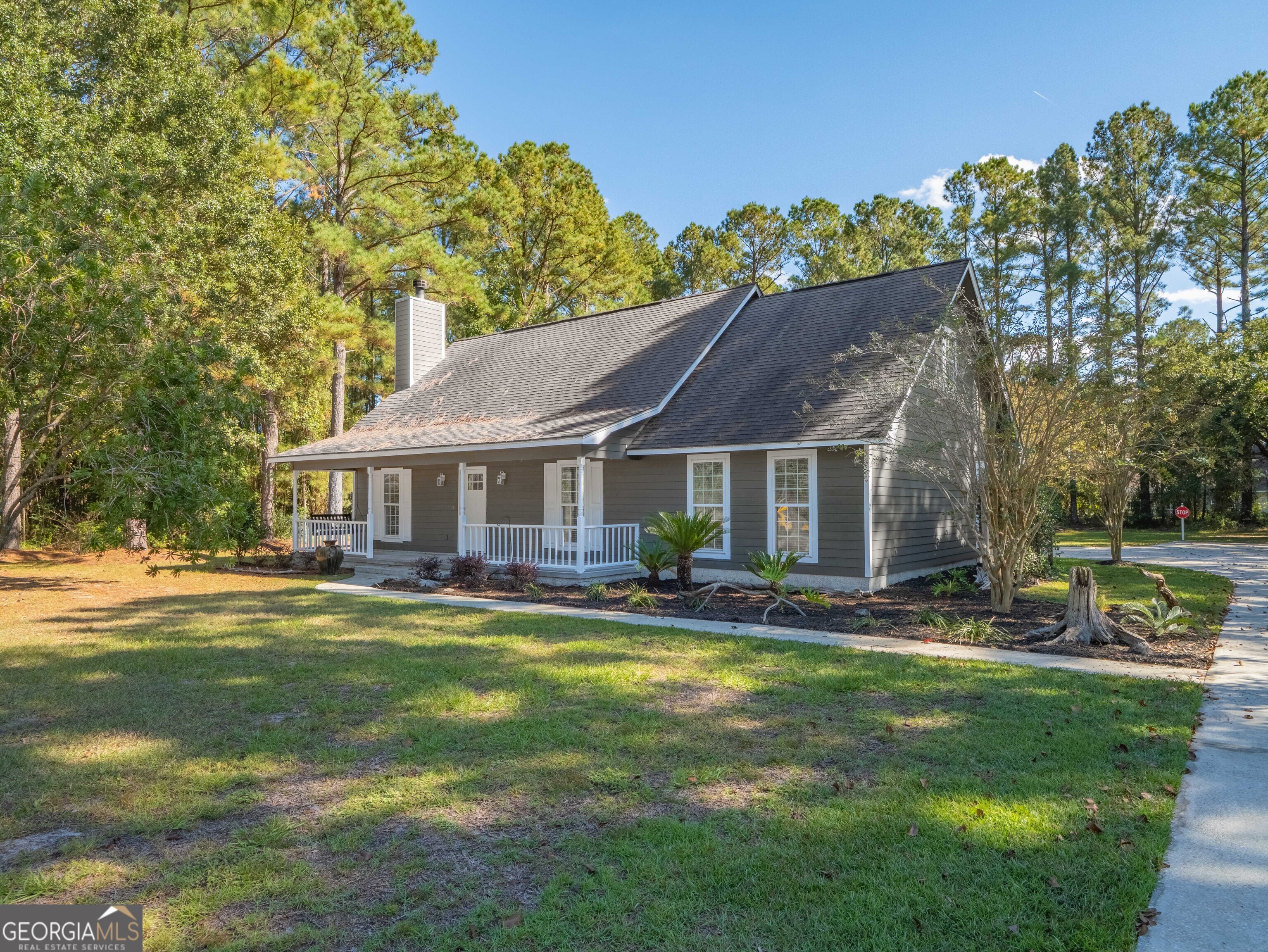 a view of a house with a yard balcony and sitting area
