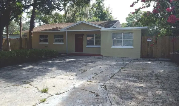 a front view of a house with a yard and a garage