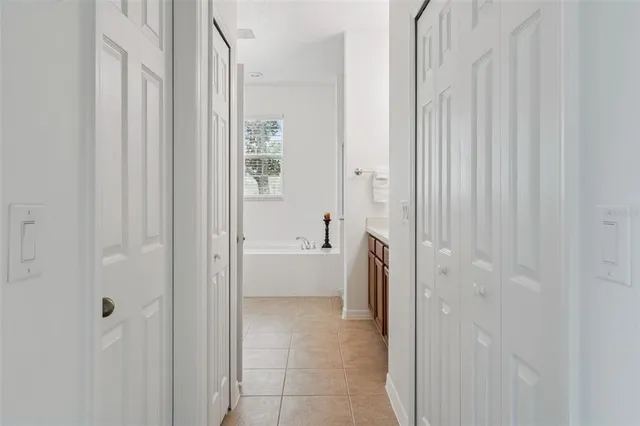 an empty room with a chandelier fan