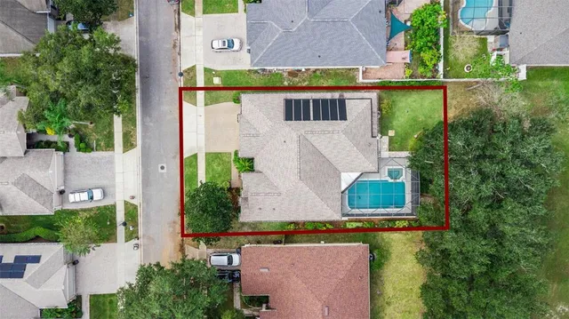 an aerial view of a house with a yard basket ball court and outdoor seating