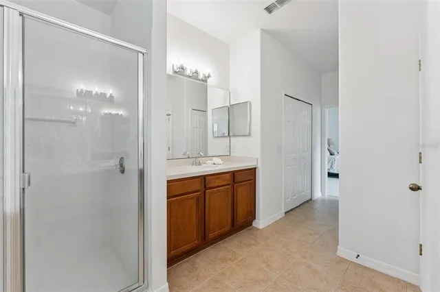 a bathroom with a granite countertop sink a toilet and a mirror