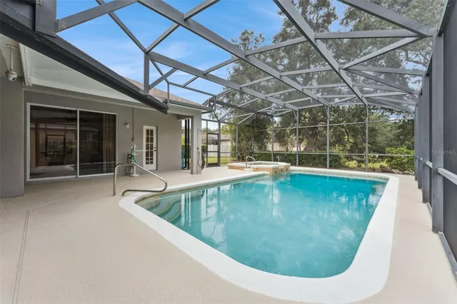 a kitchen with stainless steel appliances granite countertop a sink stove refrigerator and cabinets