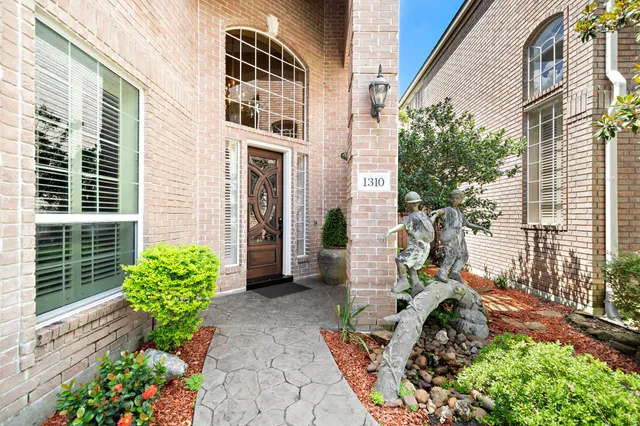 a view of a house with a yard and garden