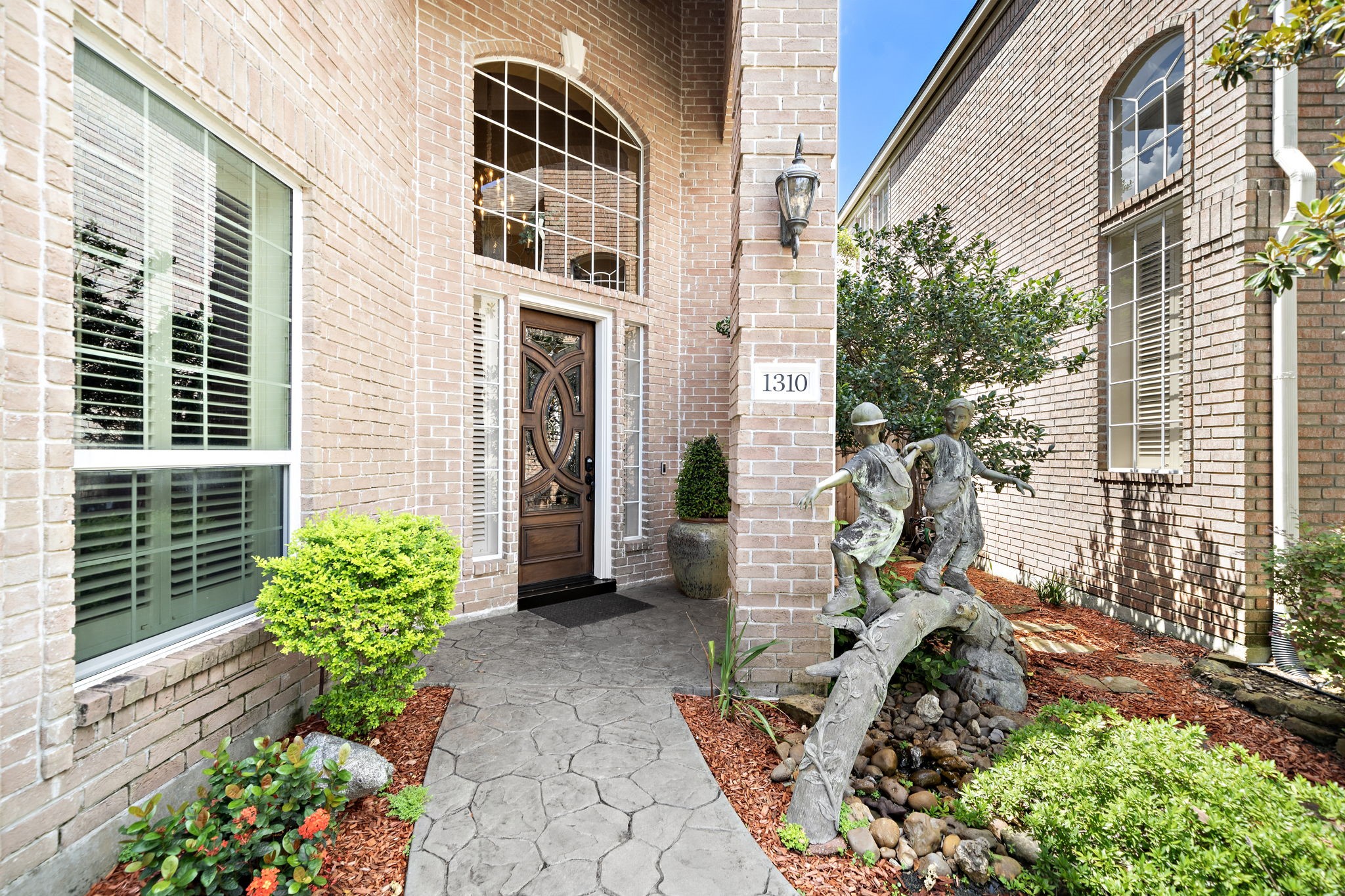 a view of a house with a yard and garden
