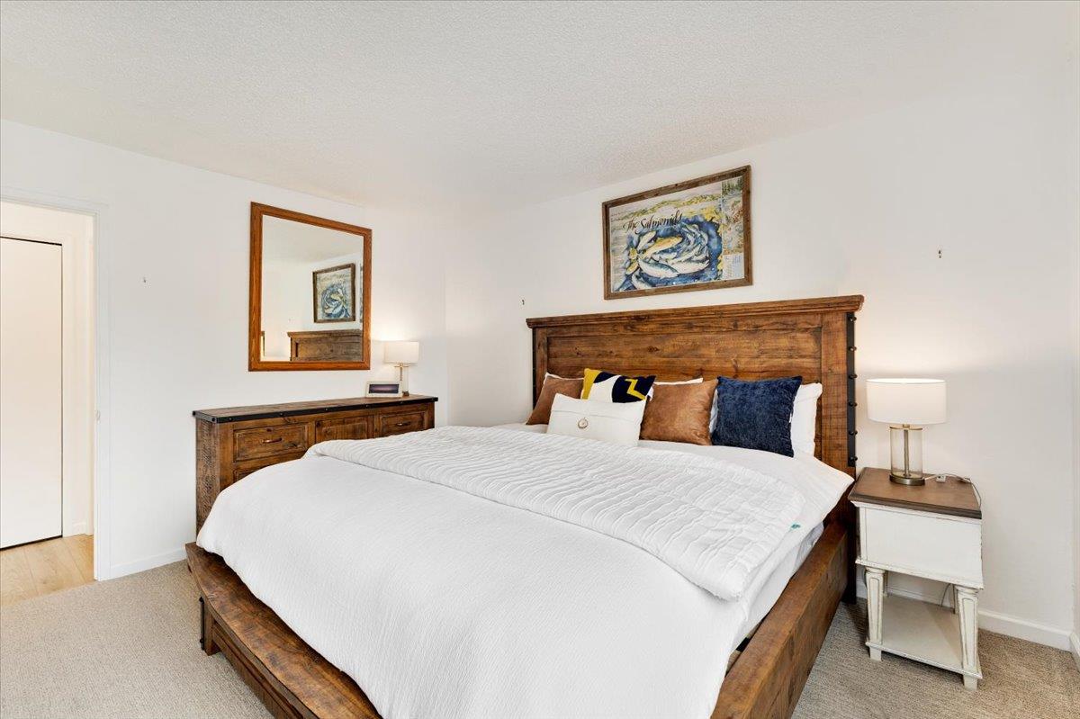 101 Shell Road, Unit 62 Watsonville, CA 95076 - Photo 20 of 38 a bedroom with a bed and a lamp on table