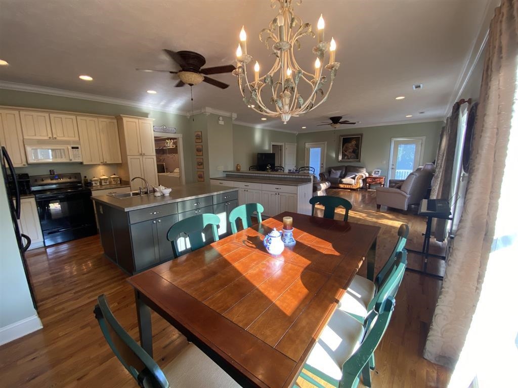 55 Old South Road Counce, TN 38326 - Photo 22 of 24 a view of a dining room with furniture a chandelier and wooden floor