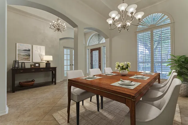 a dining room with a table or chairs and a chandelier