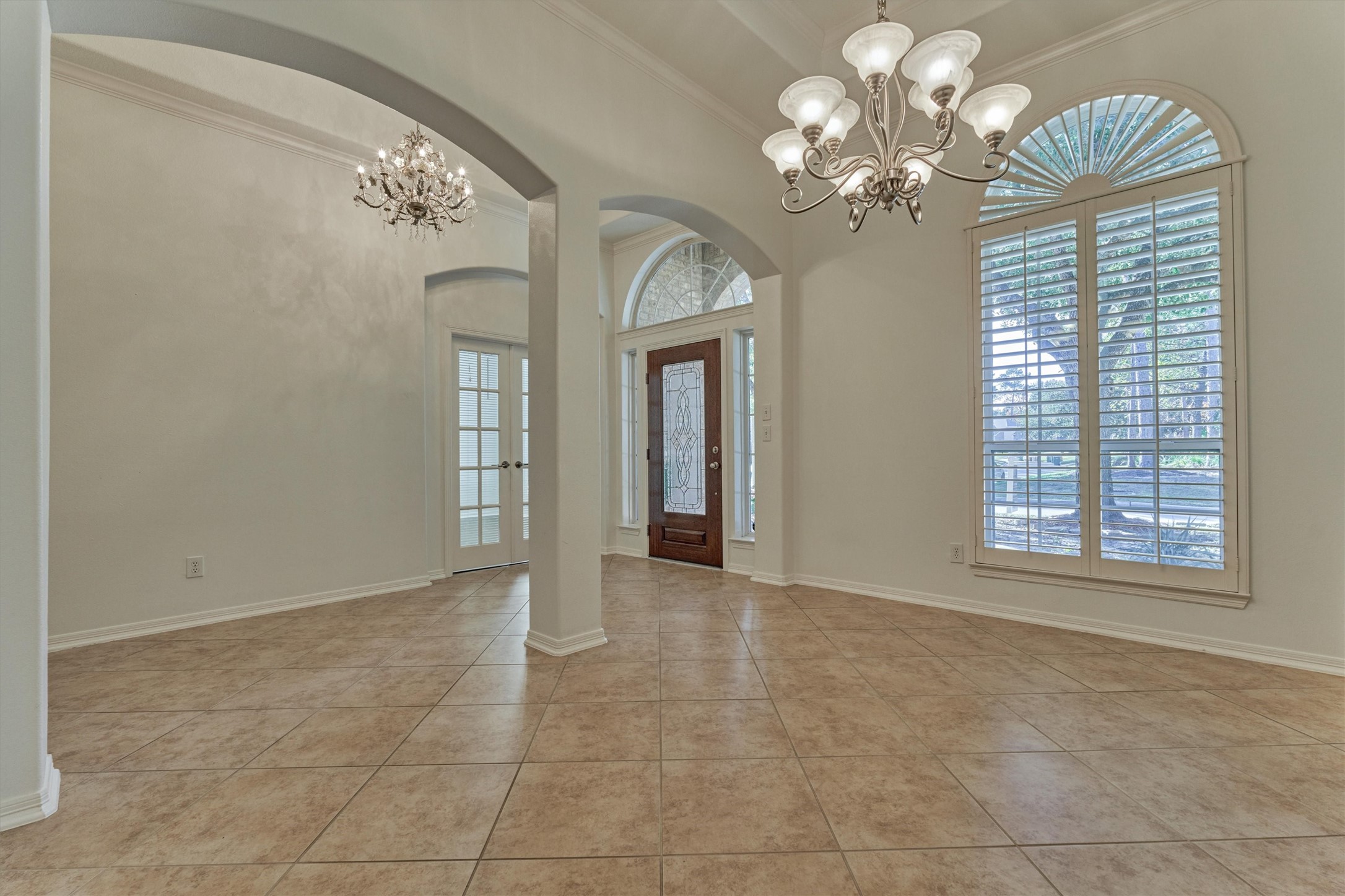 94 Oriel Oaks Circle The Woodlands, TX 77382 - Photo 12 of 46 a view of an empty room with a chandelier
