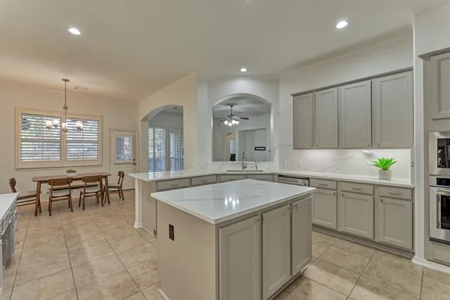 a kitchen with a sink a table and chairs
