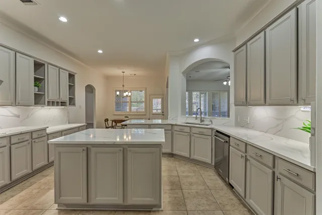 a kitchen with sink stove and cabinets