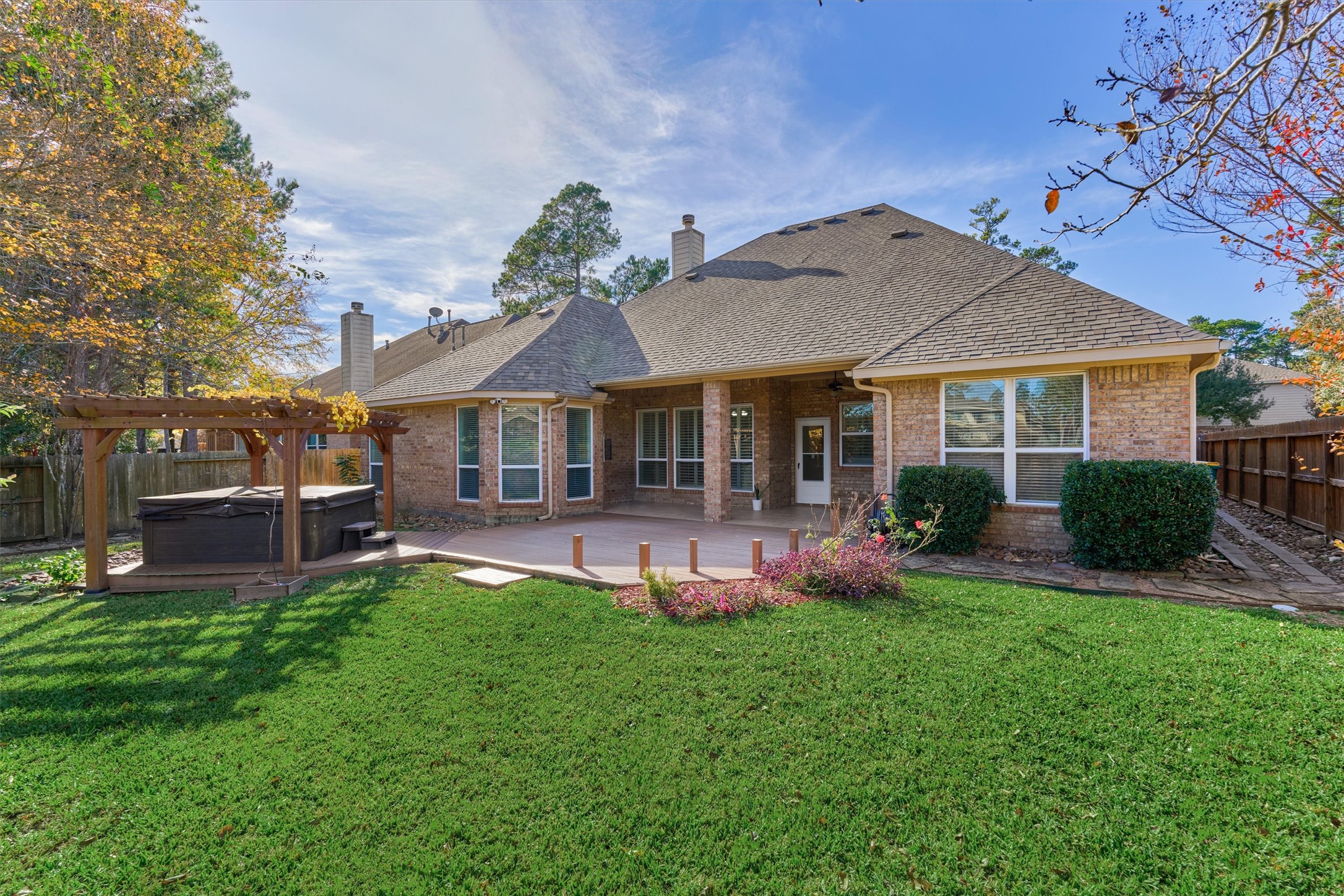 94 Oriel Oaks Circle The Woodlands, TX 77382 - Photo 2 of 46 a front view of a house with swimming pool and garden