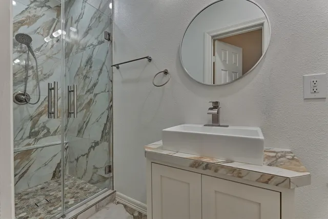 a bathroom with a sink a vanity and a mirror