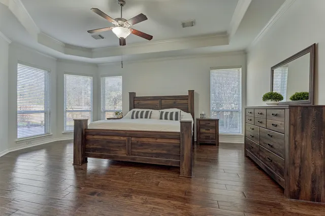 a bedroom with a bed and a dresser