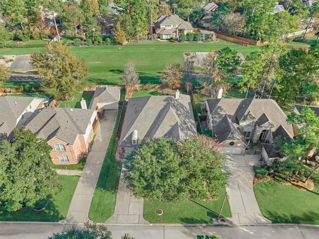 an aerial view of a house with garden space and lake view