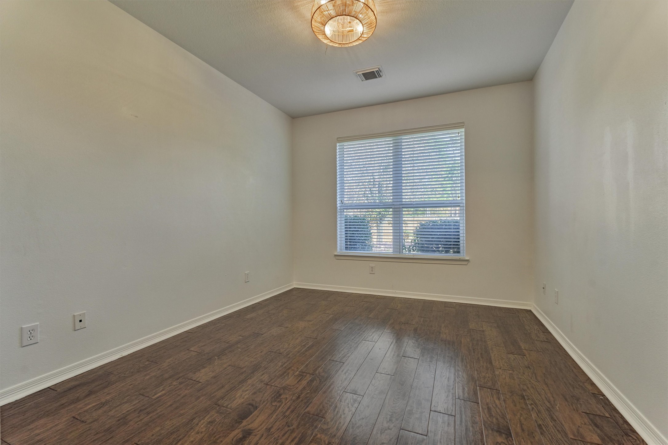 94 Oriel Oaks Circle The Woodlands, TX 77382 - Photo 45 of 46 an empty room with wooden floor and windows