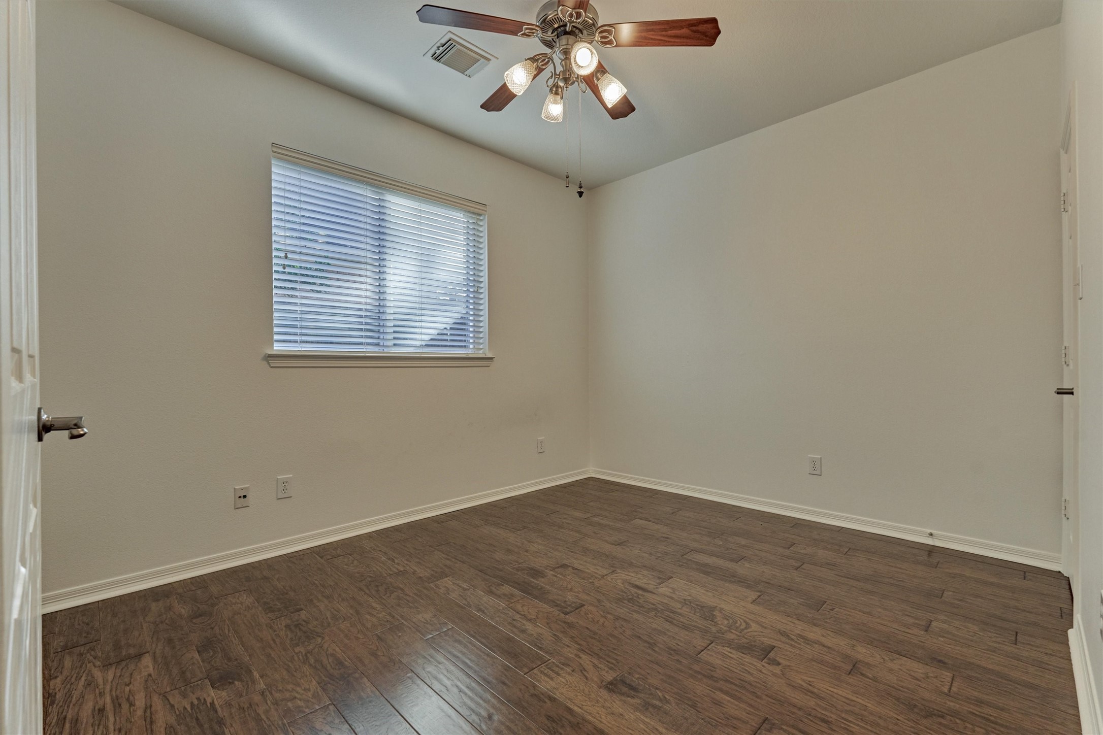 94 Oriel Oaks Circle The Woodlands, TX 77382 - Photo 36 of 46 a view of an empty room with wooden floor and a window