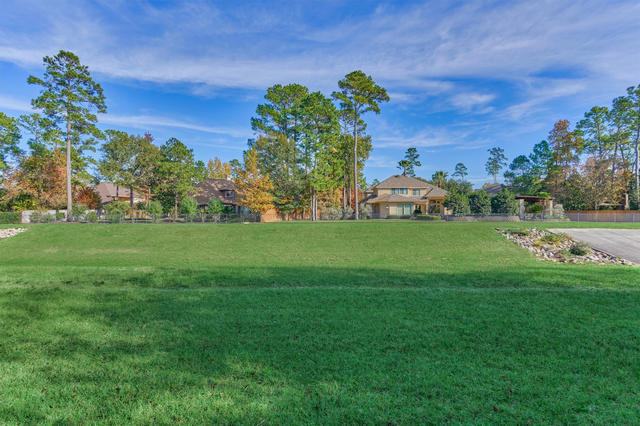 94 Oriel Oaks Circle The Woodlands, TX 77382 - Photo 41 of 46 a view of a garden with a building in the background
