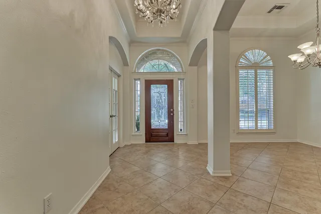 an empty room with a fireplace and a window