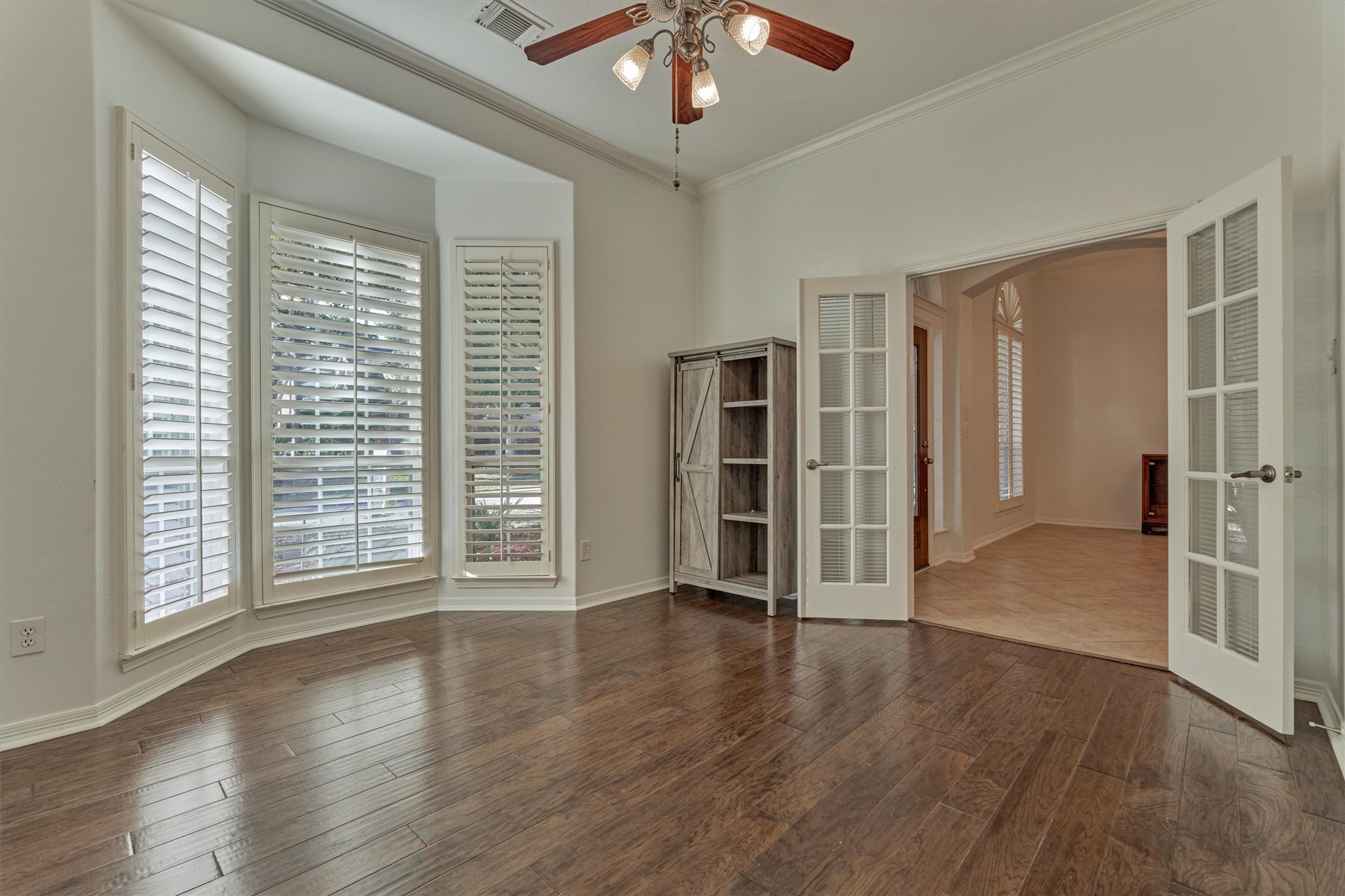 94 Oriel Oaks Circle The Woodlands, TX 77382 - Photo 8 of 46 a view of an empty room with a window and wooden floor