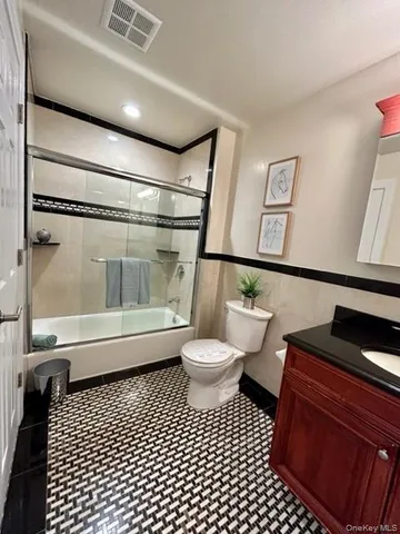 a bathroom with a toilet a sink and a shower