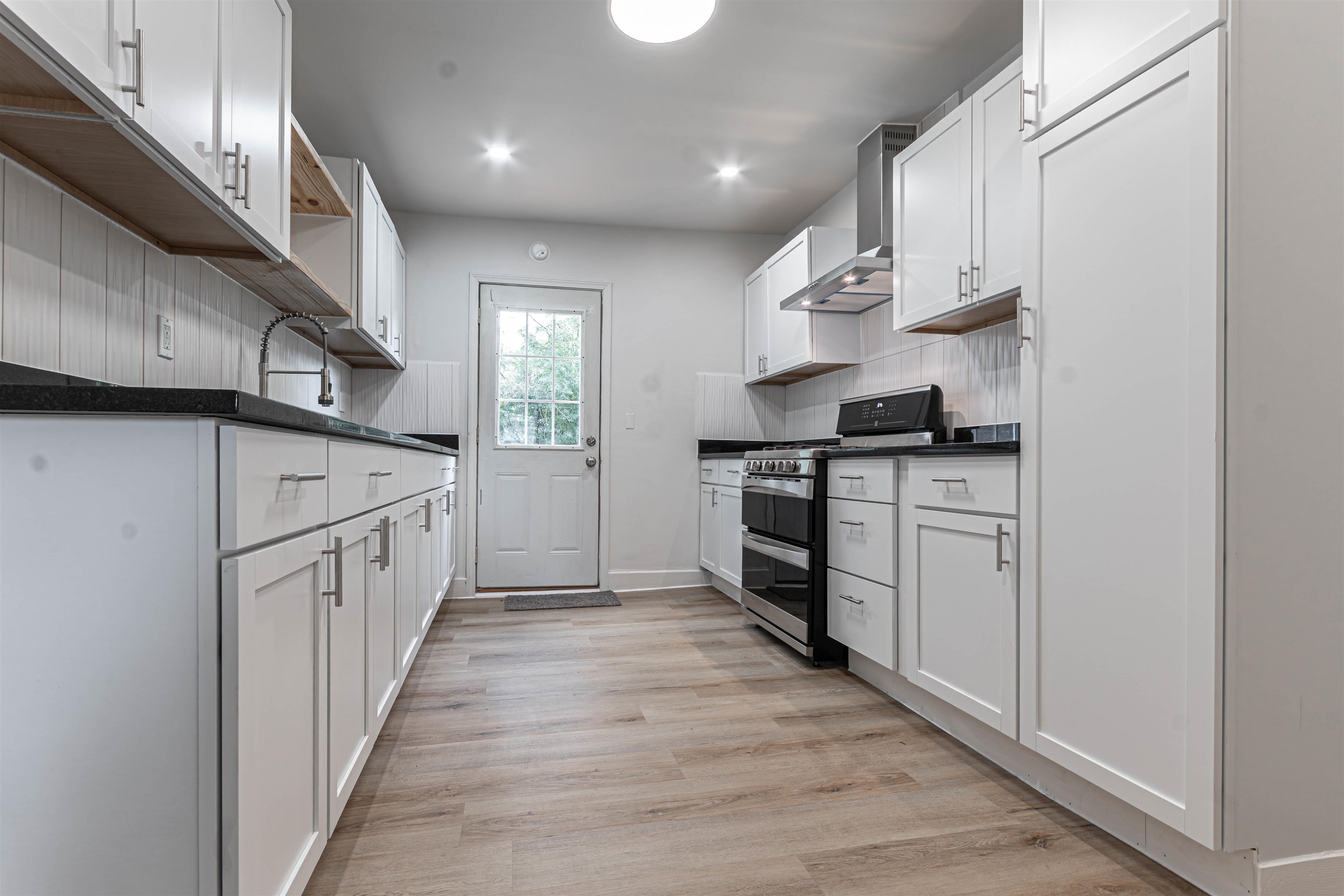 3412 Gilbert Avenue Rockford, IL 61101 - Photo 12 of 19 a kitchen with granite countertop a sink and a stove top oven