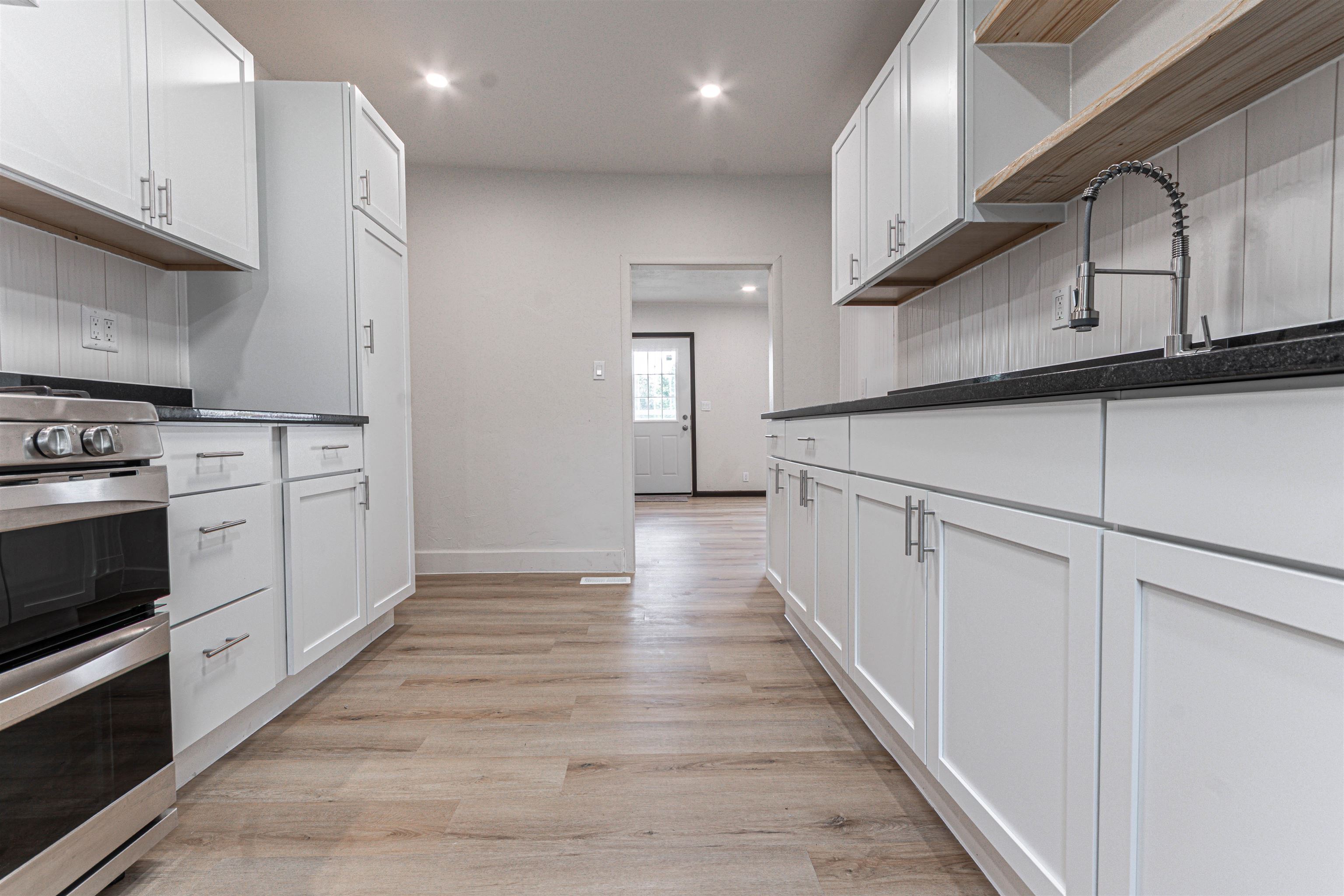3412 Gilbert Avenue Rockford, IL 61101 - Photo 13 of 19 a kitchen with cabinets wooden floor and stainless steel appliances