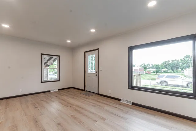 wooden floor in an empty room with a window