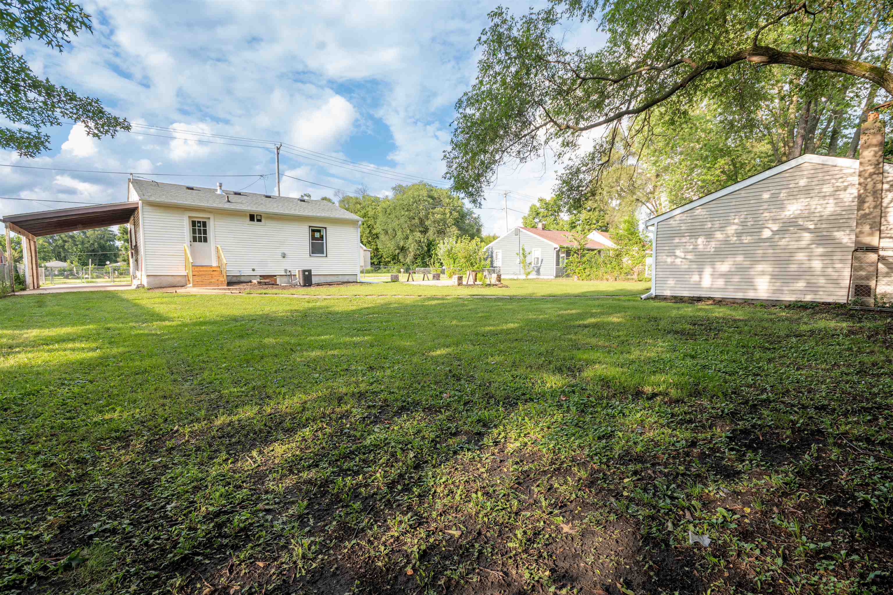 3412 Gilbert Avenue Rockford, IL 61101 - Photo 17 of 19 a view of a big house with a big yard and large trees
