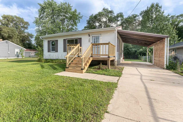 a view of a house with backyard porch and sitting area
