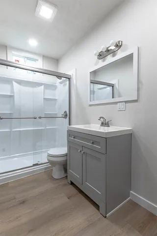 a bathroom with a toilet a sink and mirror