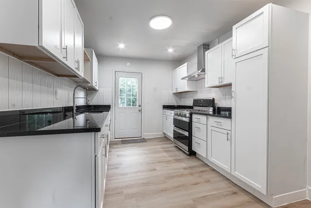 a kitchen with stainless steel appliances granite countertop a sink and cabinets
