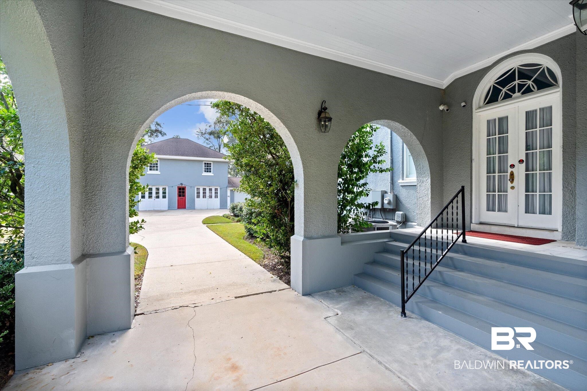 1953 Dauphin Street Mobile, AL 36606 - Photo 29 of 56 View of exterior entry featuring french doors and a garage