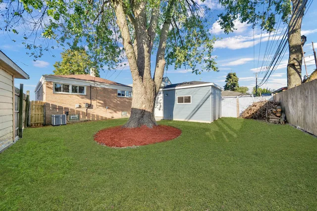 a view of an house with backyard space and garden