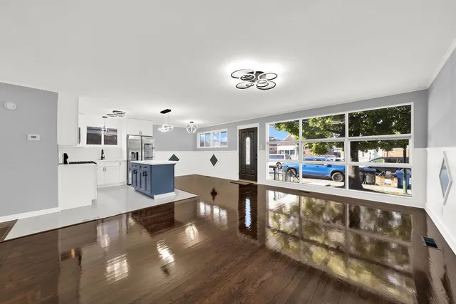 a view of a living room with furniture and a floor to ceiling window