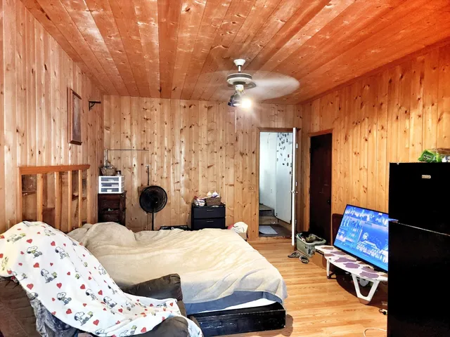 a view of a closet area with wooden floor