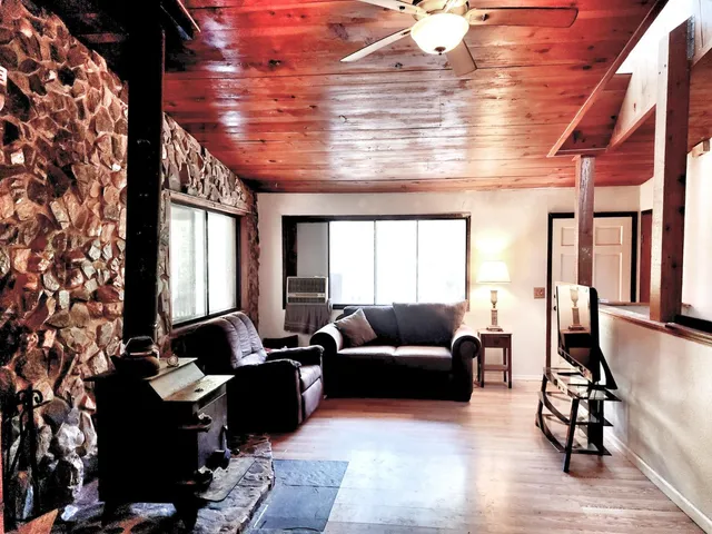 a living room with furniture and floor to ceiling window
