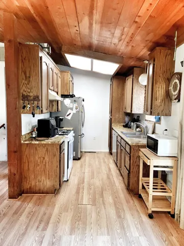 a kitchen with stainless steel appliances granite countertop a stove a sink and a refrigerator