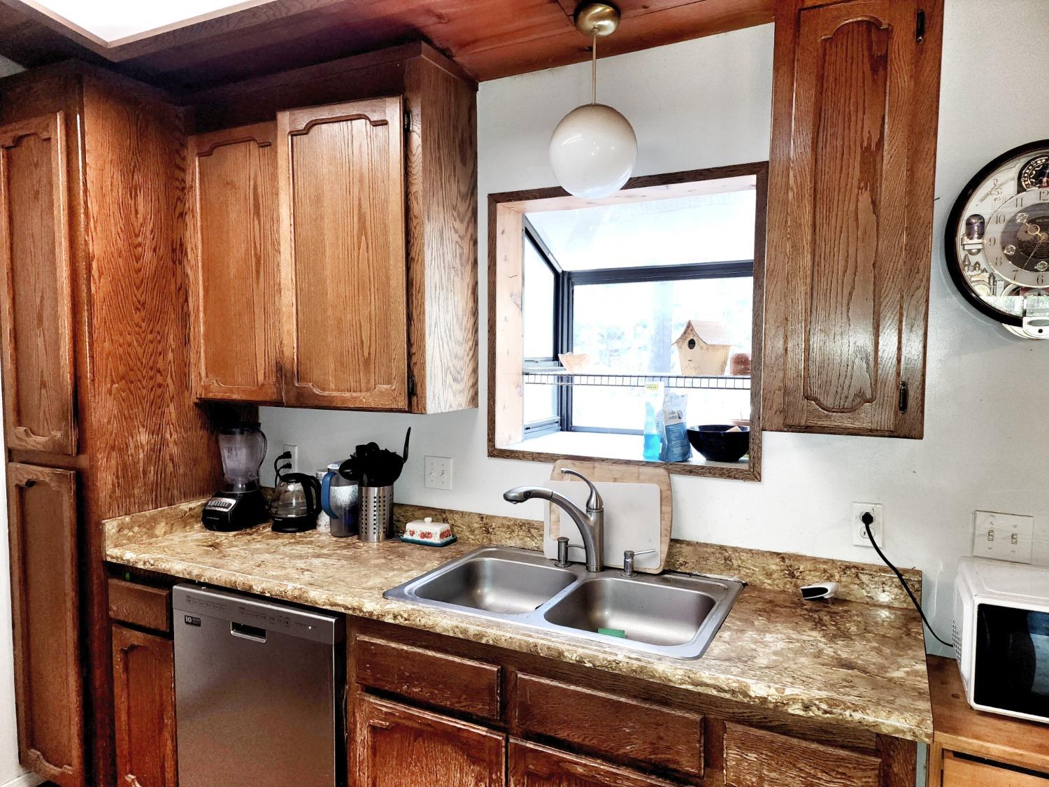 3221 Brauer Road Georgetown, CA 95634 - Photo 7 of 24 a kitchen with granite countertop a sink a stove and cabinets