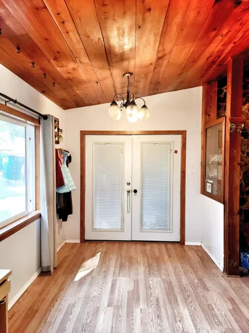 a view of a room with wooden floor and window