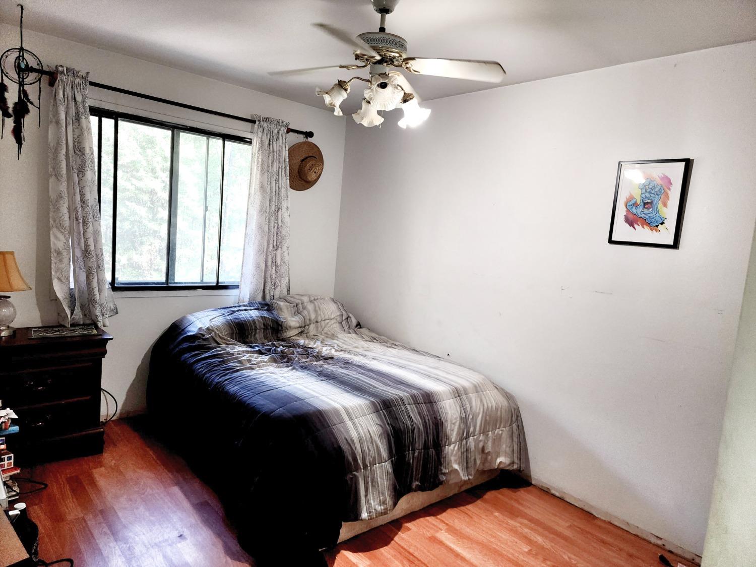 3221 Brauer Road Georgetown, CA 95634 - Photo 10 of 24 a bedroom with a bed and a chandelier