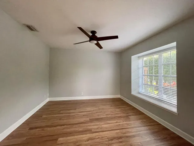 wooden floor in an empty room with a window