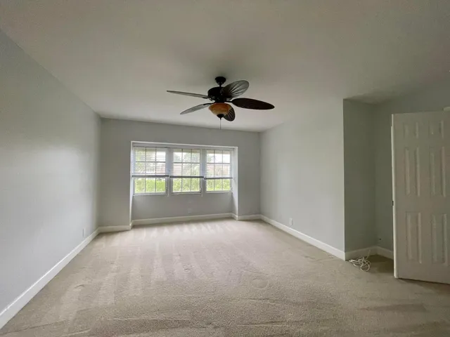 a view of empty room with ceiling fan