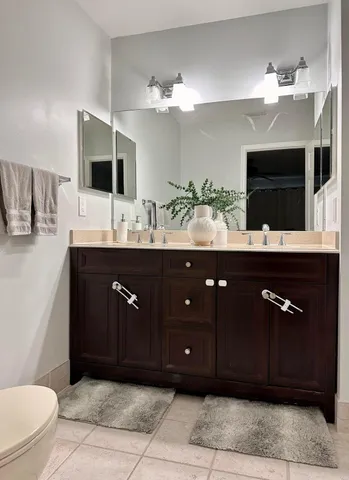 a bathroom with a sink vanity and a mirror