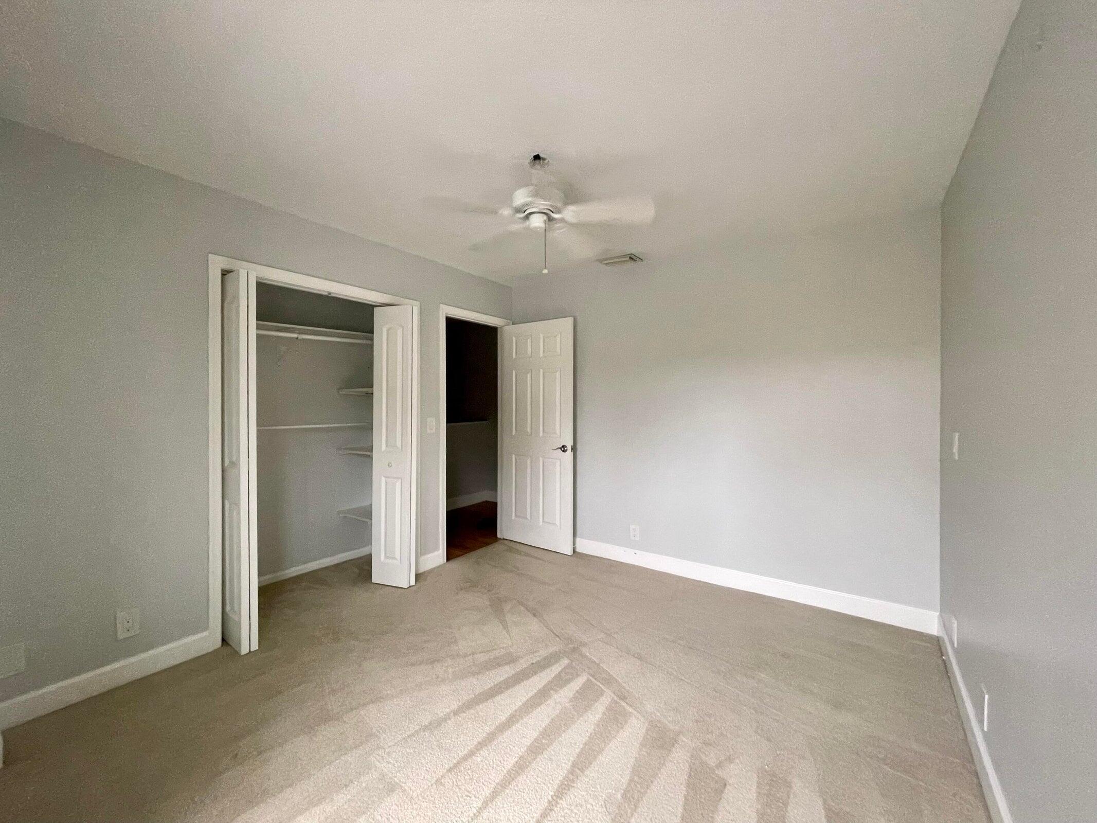11551 Winchester Drive Palm Beach Gardens, FL 33410 - Photo 19 of 22 a view of an empty room with a ceiling fan