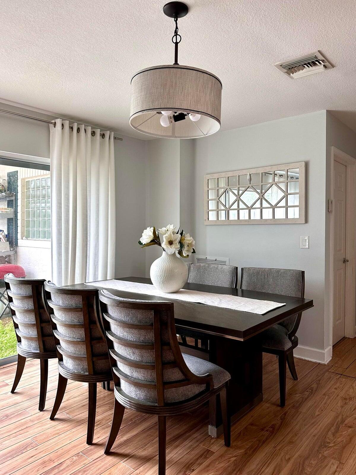 11551 Winchester Drive Palm Beach Gardens, FL 33410 - Photo 9 of 22 a table and chairs in a room with a window